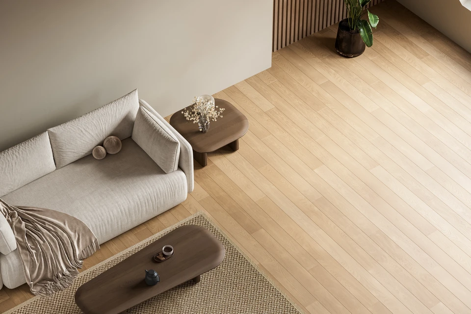 Parquet en bois naturel aux teintes brunes et miel, disposé en lames rectangulaires de longueurs variables selon un motif à joints décalés